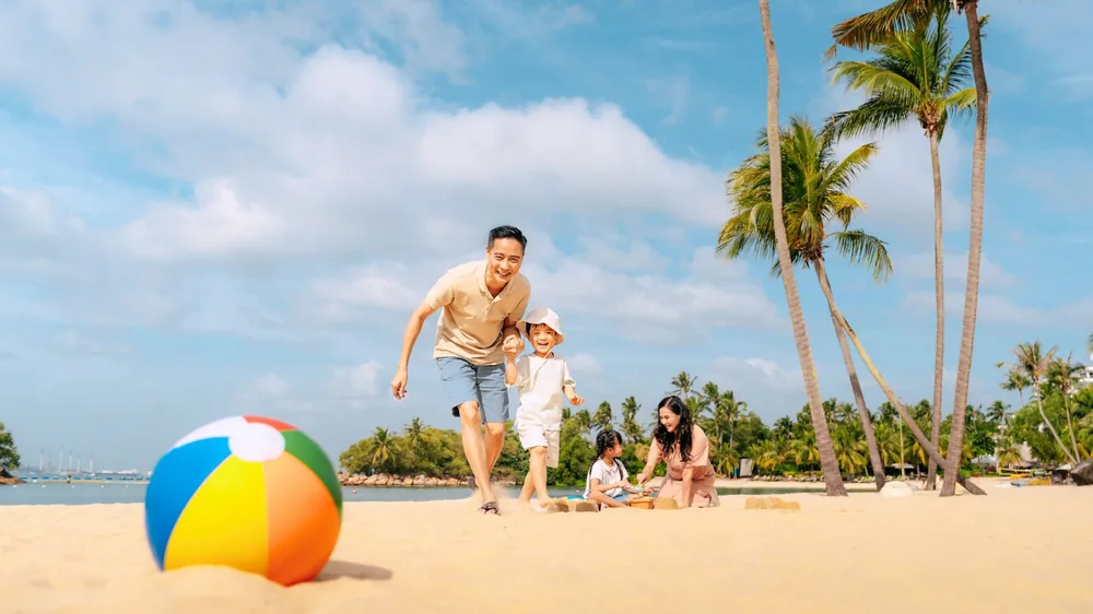 Family on Siloso Beach, Sentosa — Mastercard 1-for-1 attractions promo